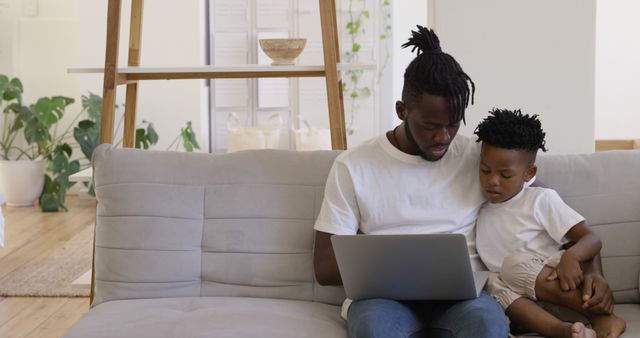 Father and Son Using Laptop Together in Living Room - Download Free Stock Images Pikwizard.com