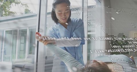 Therapist guiding rehabilitation session through glass partition