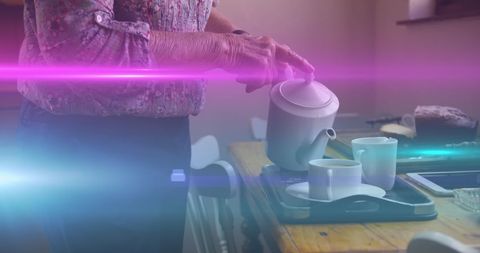 Senior Woman Pouring Tea with Dreamlike Light Effects