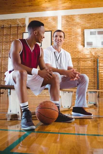 Smiling coach and player talking in court - Download Free Stock Photos Pikwizard.com
