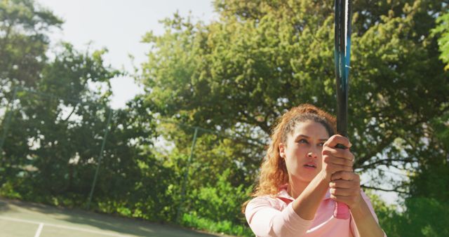 Image of happy biracial woman playing tennis on the court - Download Free Stock Photos Pikwizard.com