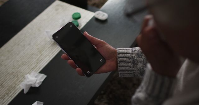 Senior Person Holding Smartphone While Coughing at Home - Download Free Stock Images Pikwizard.com