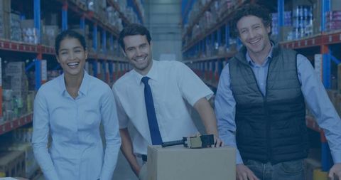 Team of diverse warehouse workers posing in aisle
