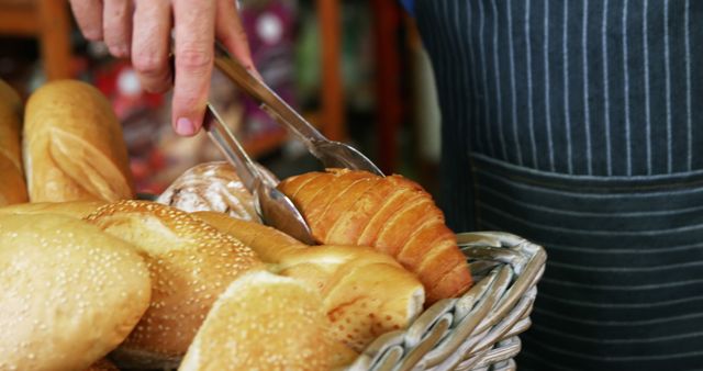 Baker Selecting Fresh Croissant from Bread Basket - Download Free Stock Images Pikwizard.com