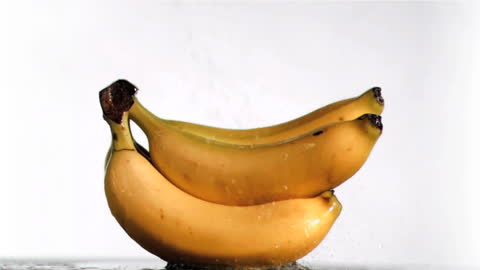 Fresh Bananas with Water Splashing in Super Slow Motion