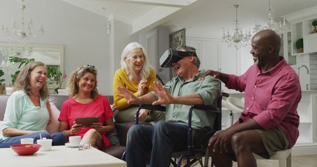 Group of senior friends gathered in modern living room. One wearing VR headset and experiencing virtual reality while others laugh and engage. Great for promoting technology for seniors, digital inclusivity, and social activities in aging communities. Also ideal for illustrating themes of joy, friendship, and leisure time.