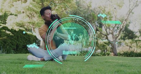 Man kissing small dog on lawn with futuristic holographic data overlay conveying pet tech