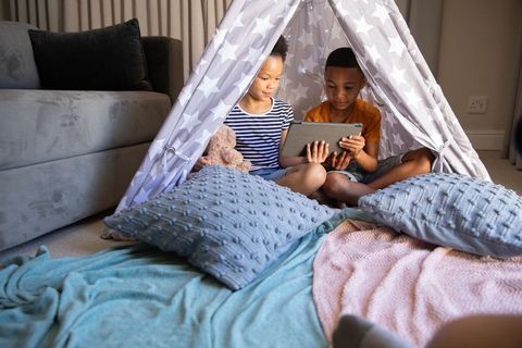 Children Enjoying Screen Time Inside Cozy Teepee Tent