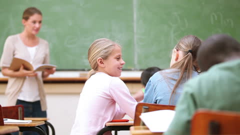 Students Collaborating in Classroom with Teacher Supervising