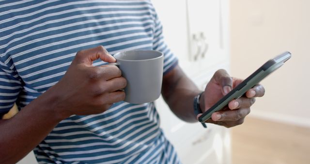 Man Drinking Coffee Reading Mobile Phone Message Indoors - Download Free Stock Images Pikwizard.com