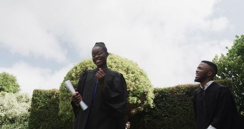 Joyful Graduates Celebrating Outdoor Achievement with Smiles
