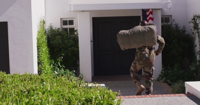 African american male soldier holding bag and going back home. Spending quality time at home.