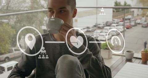 Man Enjoying Coffee with Futuristic Digital Icons Overlay