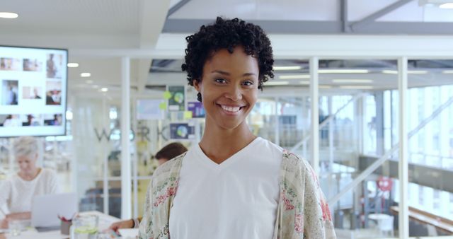 Confident Female Professional Smiling in Contemporary Office - Download Free Stock Images Pikwizard.com