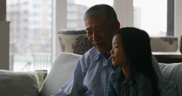 Grandfather and Granddaughter Bonding on Couch at Home - Download Free Stock Images Pikwizard.com