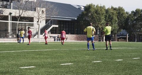 Referee officiating soccer game on clear day
