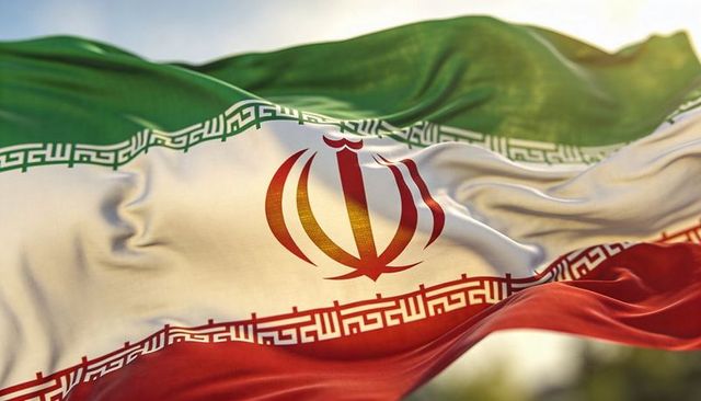 Waving iranian flag closeup red emblem kufic border sunlit fabric texture