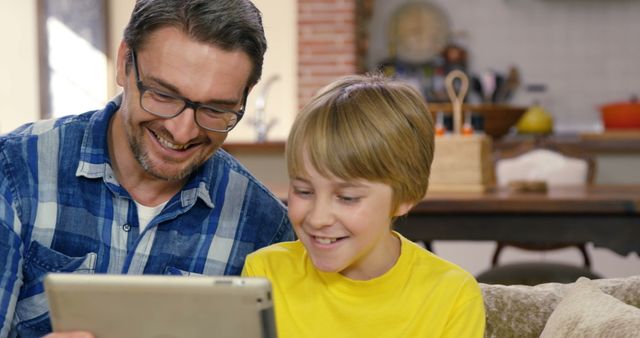 Father and Son Bonding Over Tablet Inside Cozy Kitchen - Download Free Stock Images Pikwizard.com