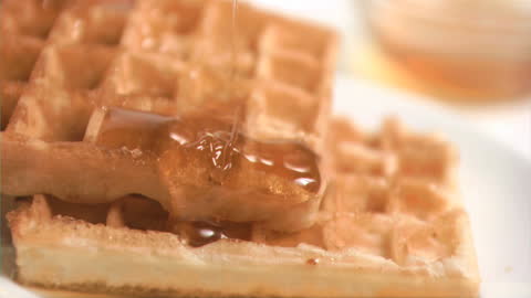 Slow Motion Honey Drizzling Over Crispy Waffles