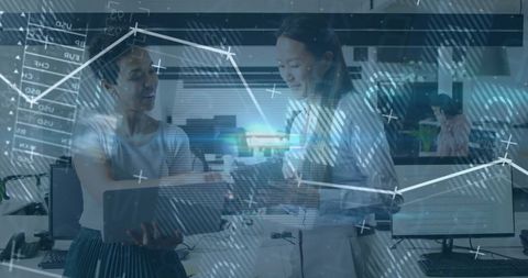 Business Women Collaborating with Digital Data Overlay in Modern Office
