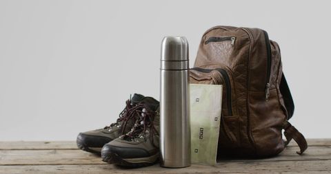 Adventure gear with backpack, thermos, and hiking boots