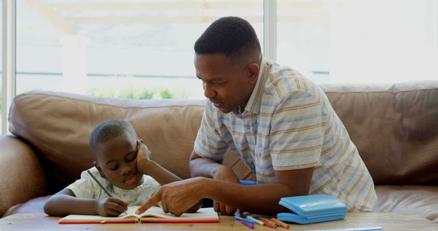 Father Helping Son with Homework on Living Room Couch - Download Free Stock Images Pikwizard.com