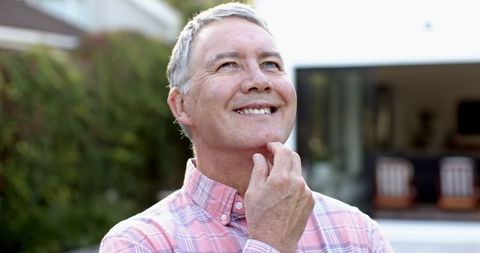 Senior Man Relaxing Outdoors in Casual Attire