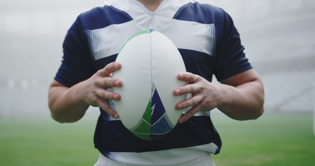 Rugby Player Holding Ball on Football Field - Download Free Stock Images Pikwizard.com