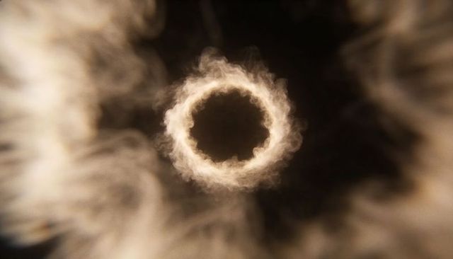 Glowing smoke ring vortex with amber halo in dark void for mystical abstract design
