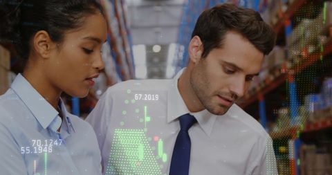 Diverse Professionals Analyzing Digital Data in Warehouse Environment