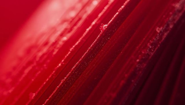 Vibrant red textured macro with dewy droplets