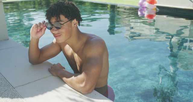 Young Man Relaxing in Swimming Pool on Sunny Day - Download Free Stock Images Pikwizard.com