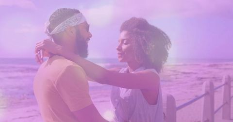 Couple Embracing on Sunny Beach with Dreamy Light Effects