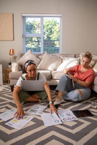 Female Friends Studying and Knitting in Cozy Living Room