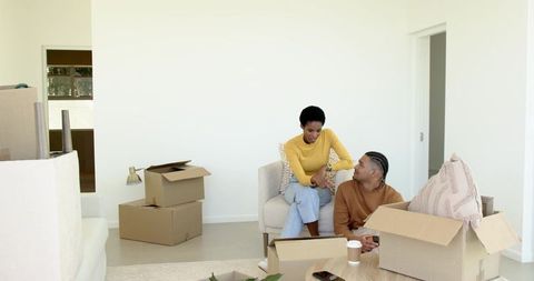 Couple Unpacking in New Home Living Room