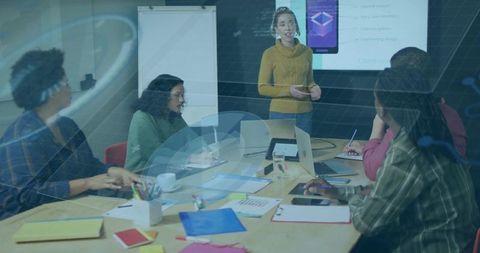 Team Presenting UX Pitch in Modern Boardroom with Laptops, Remote and Collaboration Slides