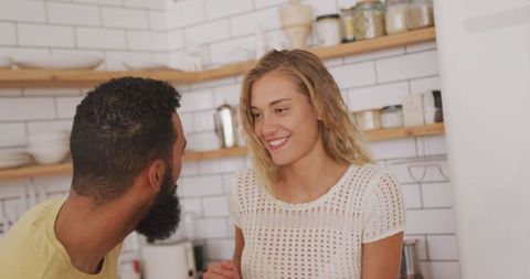 Happy couple enjoying weekend in cozy kitchen