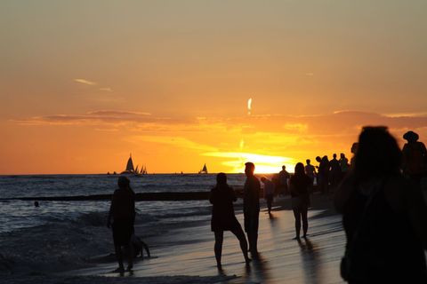 Silhouetted Crowd Enjoying Sunset at Tropical Beach