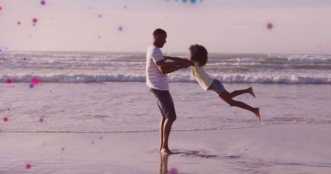 Father and Daughter Enjoying a Playful Beach Moment