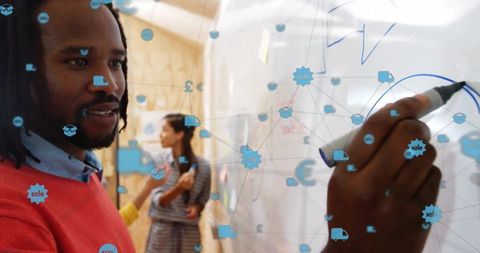 Black team leader writing on whiteboard with logistics icons overlay during brainstorm