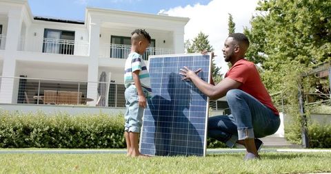 Father and Son Explore Solar Energy at Home Outdoors
