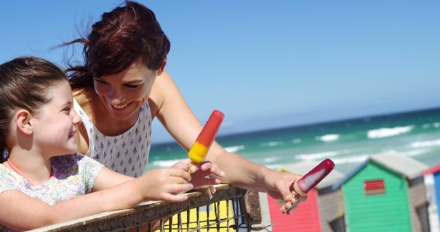 Mother and Daughter at Beach Eating Popsicles on Sunny Day - Download Free Stock Images Pikwizard.com