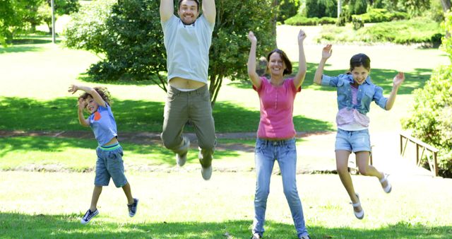 Happy Family Jumping Together in Park - Download Free Stock Images Pikwizard.com