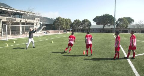 Soccer Coach Leading Training Session on School Field