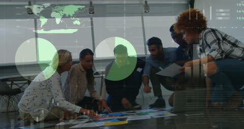 Dynamic Business Team Analyzing Data Reports on Floor