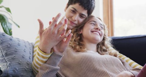 Happy Lesbian Couple Embracing and Holding Hands on Sofa - Download Free Stock Images Pikwizard.com