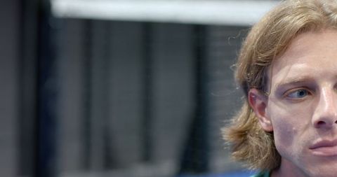 Determined Male Athlete in Gym Environment with Copy Space