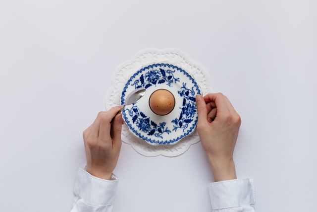Person Holding Blue and White China Plate with Boiled Egg - Download Free Stock Photos Pikwizard.com