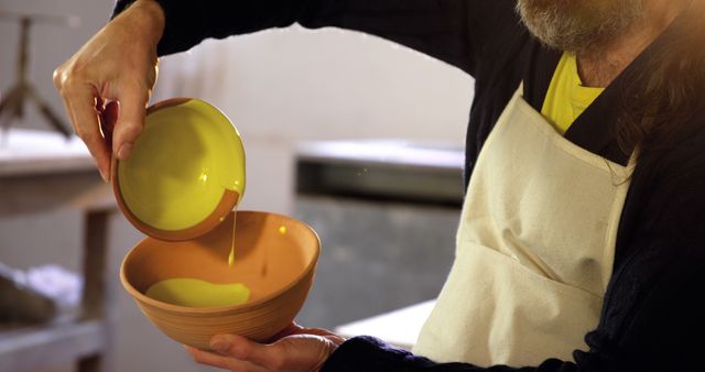 Potter Pouring Glaze into Ceramic Bowl in Workshop - Download Free Stock Images Pikwizard.com