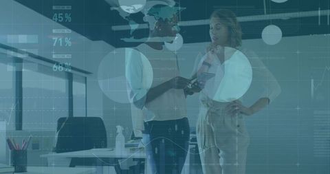 Two businesswomen collaborating with tablet and data overlays in modern office